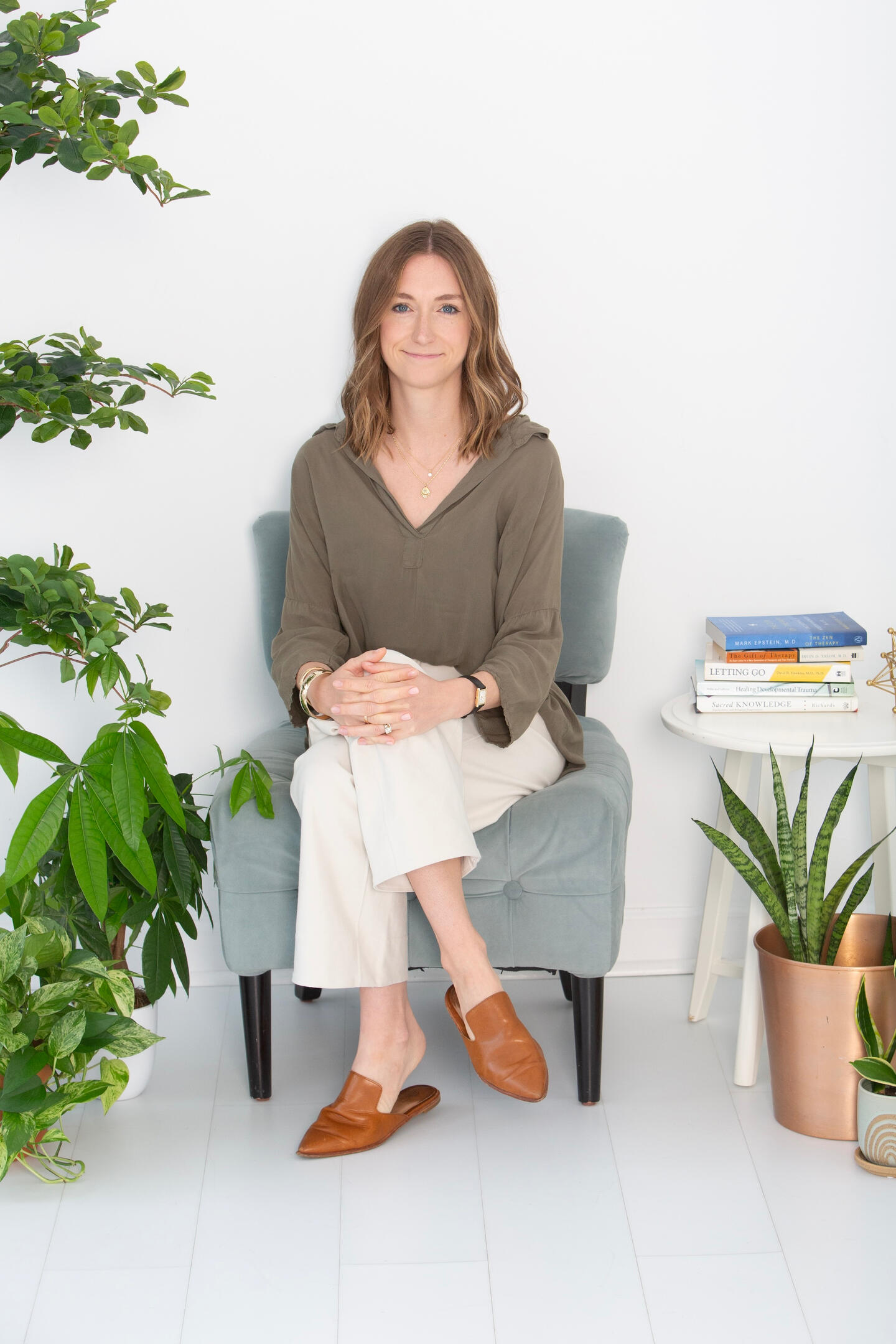 Kate, therapist at The Marsh Integrative Therapy, seated in her plant-filled office